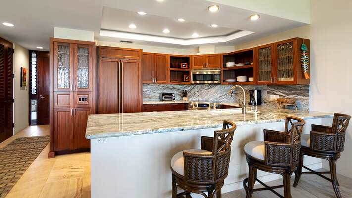 The kitchen has large, top of the line appliances, modern cabinetry, granite countertops