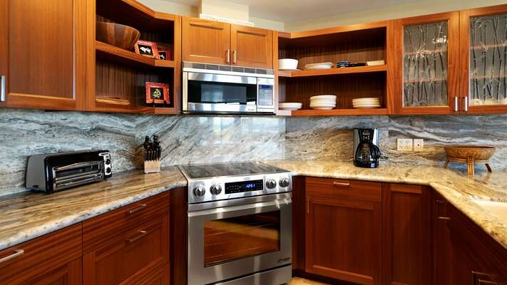 Fully equipped kitchen with modern cabinetry, granite countertops
