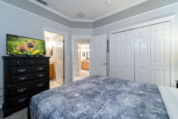 Bedroom 2 showing flatscreen TV and en-suite bathroom