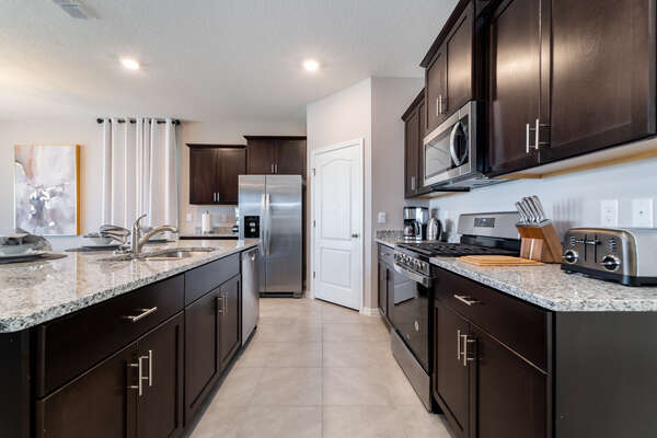 Kitchen is galley style with brushed stainless appliances