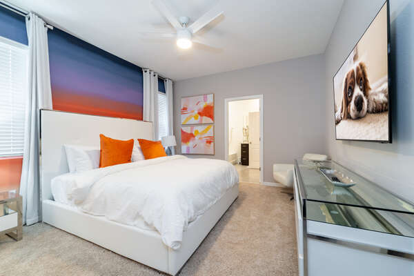 Master bedroom showing wall mounted flatscreen TV and bathroom
