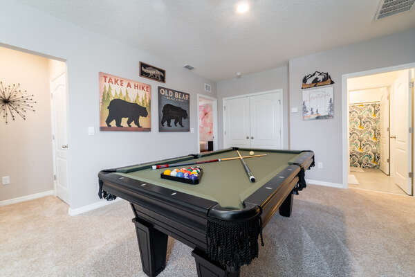 The upstairs loft has a pool table and bar area