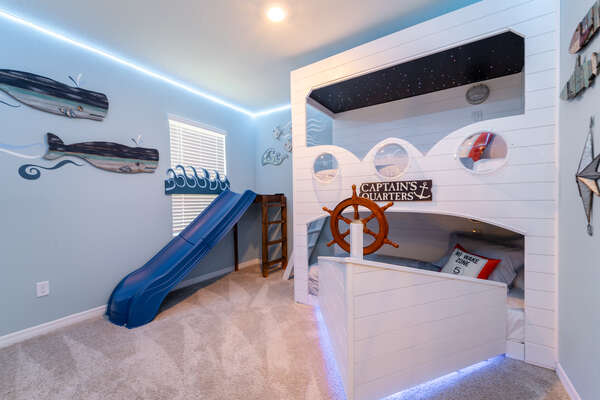 Captain themed kid's room with bunk beds and separate slide