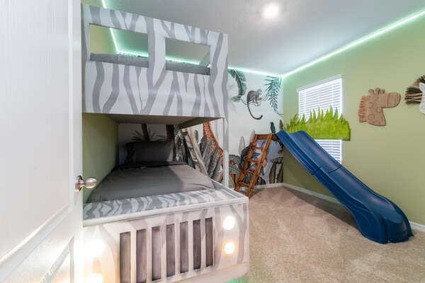 Jungle themed kid's room with 'land rover' style bunk beds and separate slide