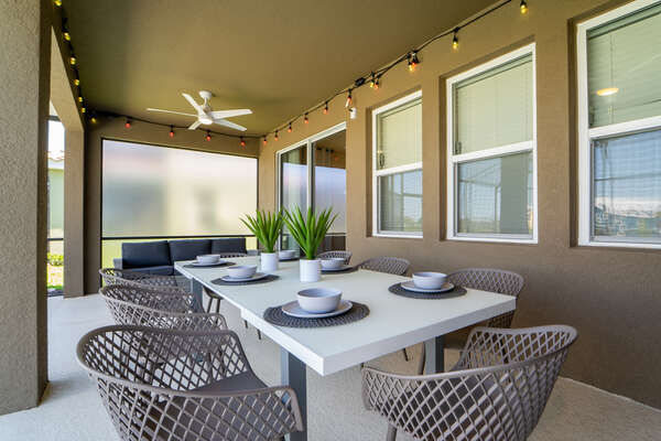Shaded lanai area with accent lighting.  The perfect spot for enjoying meals outdoors