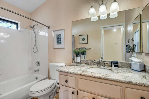 Shared Full Bathroom with Tub Shower Combo located on First Floor