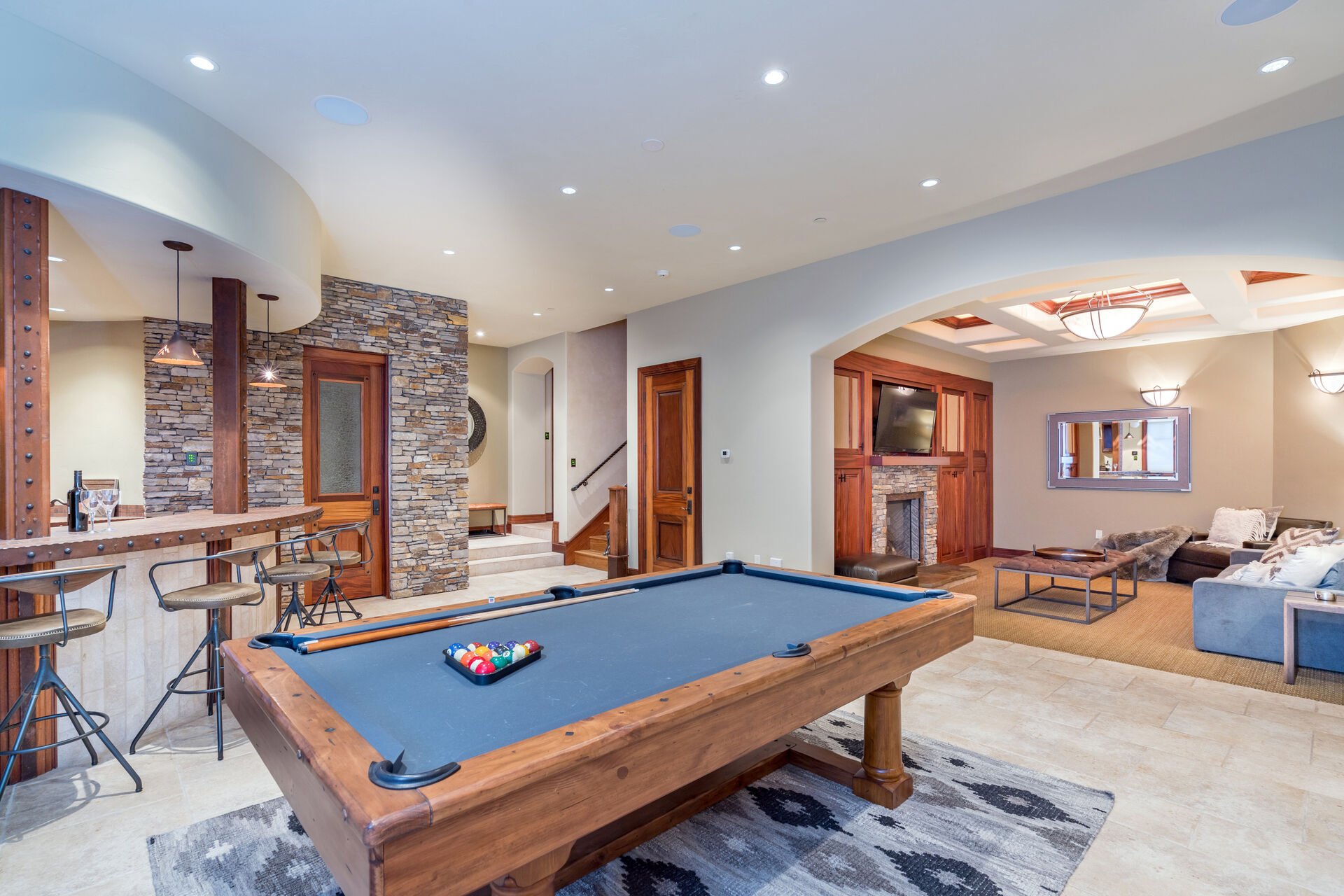 The downstairs entertainment area includes a pool table