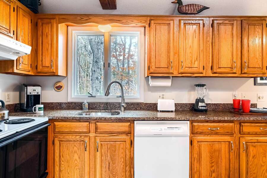 Warm wood cabinets and counters in the kitchen at 75 Candlewood Drive-Eastham-Cape Cod -