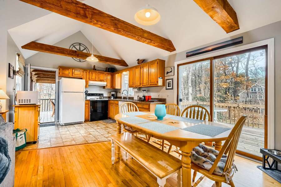 Dining area spills into the kitchen and slider provides access to the deck-75 Candlewood Drive-Eastham-Cape Cod -