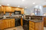 Fully Equipped Kitchen with stone countertops, GE appliances, and bar seating for two