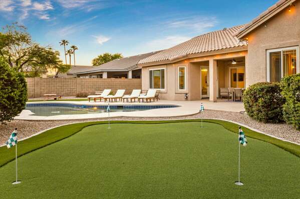 Putting Green w/ Pool & Sun Beds in Background