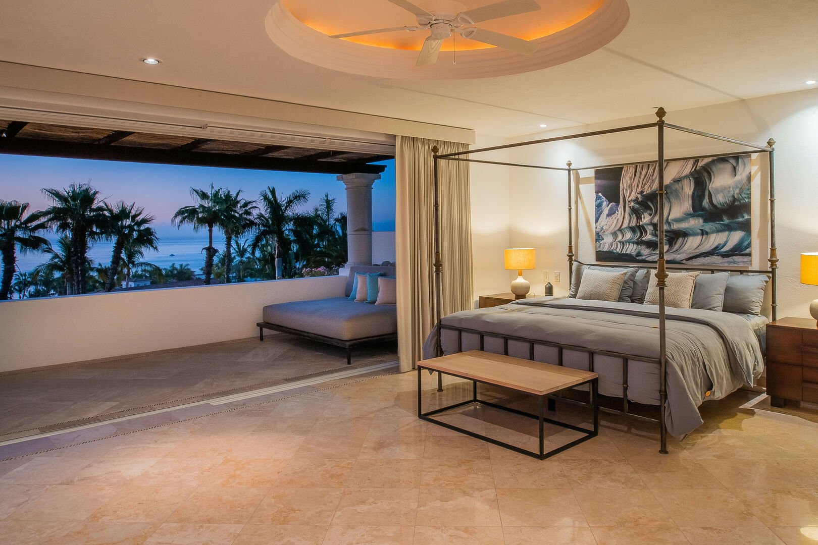 A master bedroom in this Los Cabos villa with a large balcony.