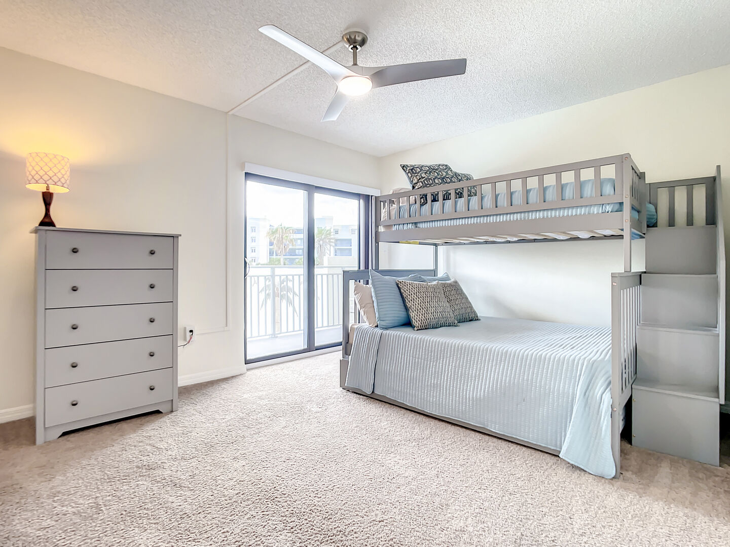 Bunkbed with a single over a double. 
Additional twin trundle underneath.  Access to the pool view balcony.