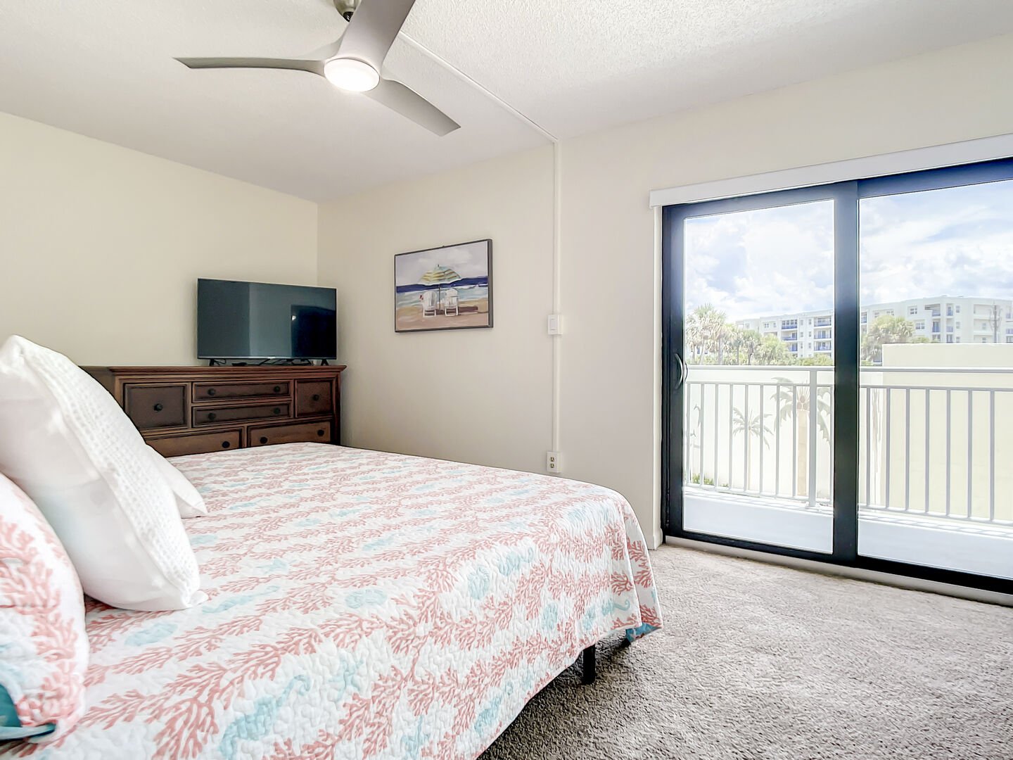 The spacious master bedroom offers a king size bed, flat screen TV and sliders to the balcony.