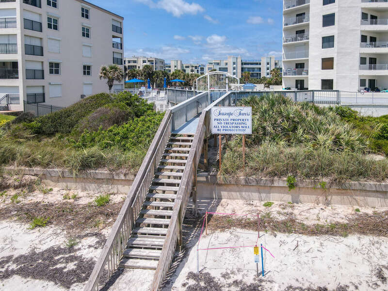 Steps down to the beach from the sun desk and shuffle board area.