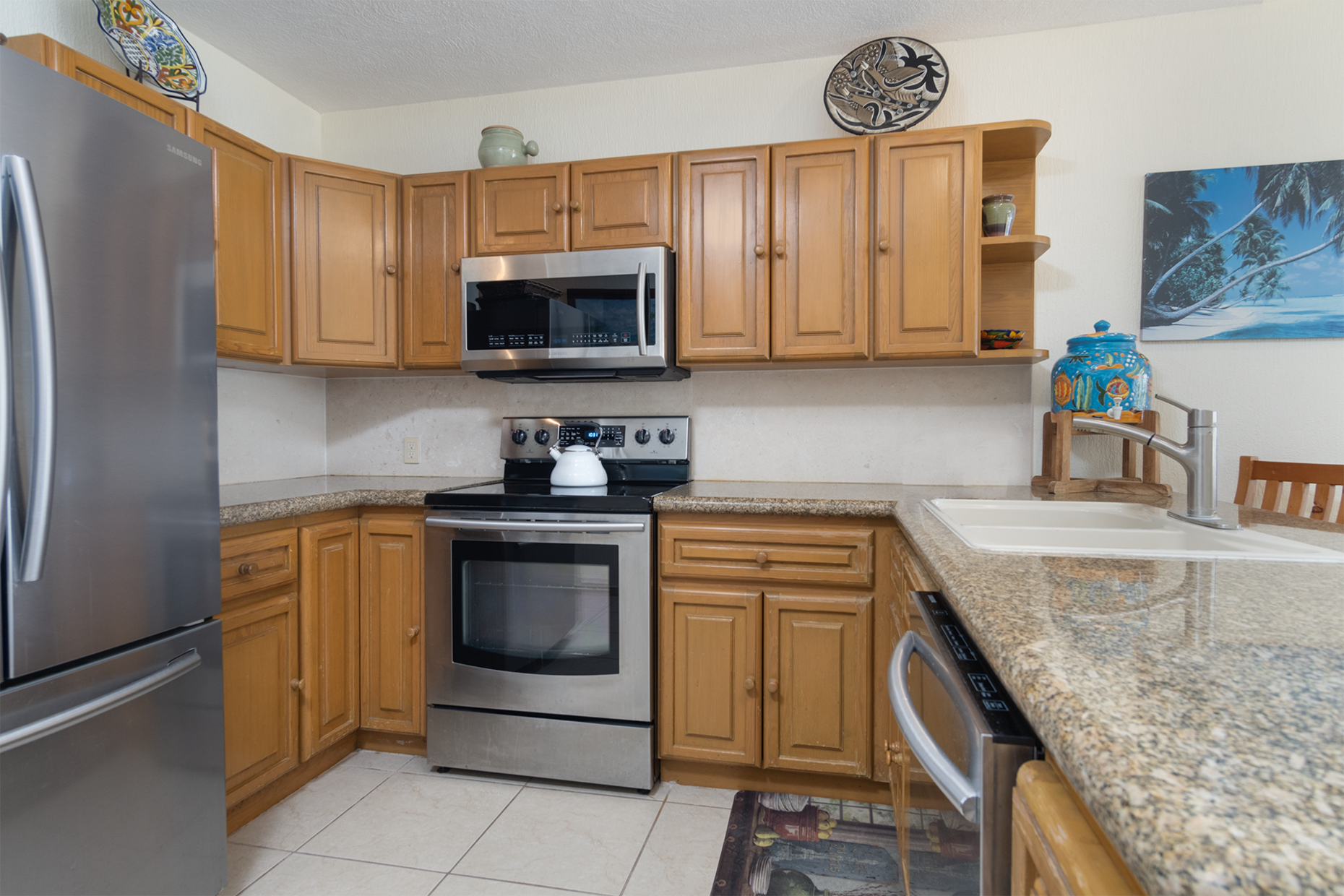 The kitchen with cabinets and appliances.