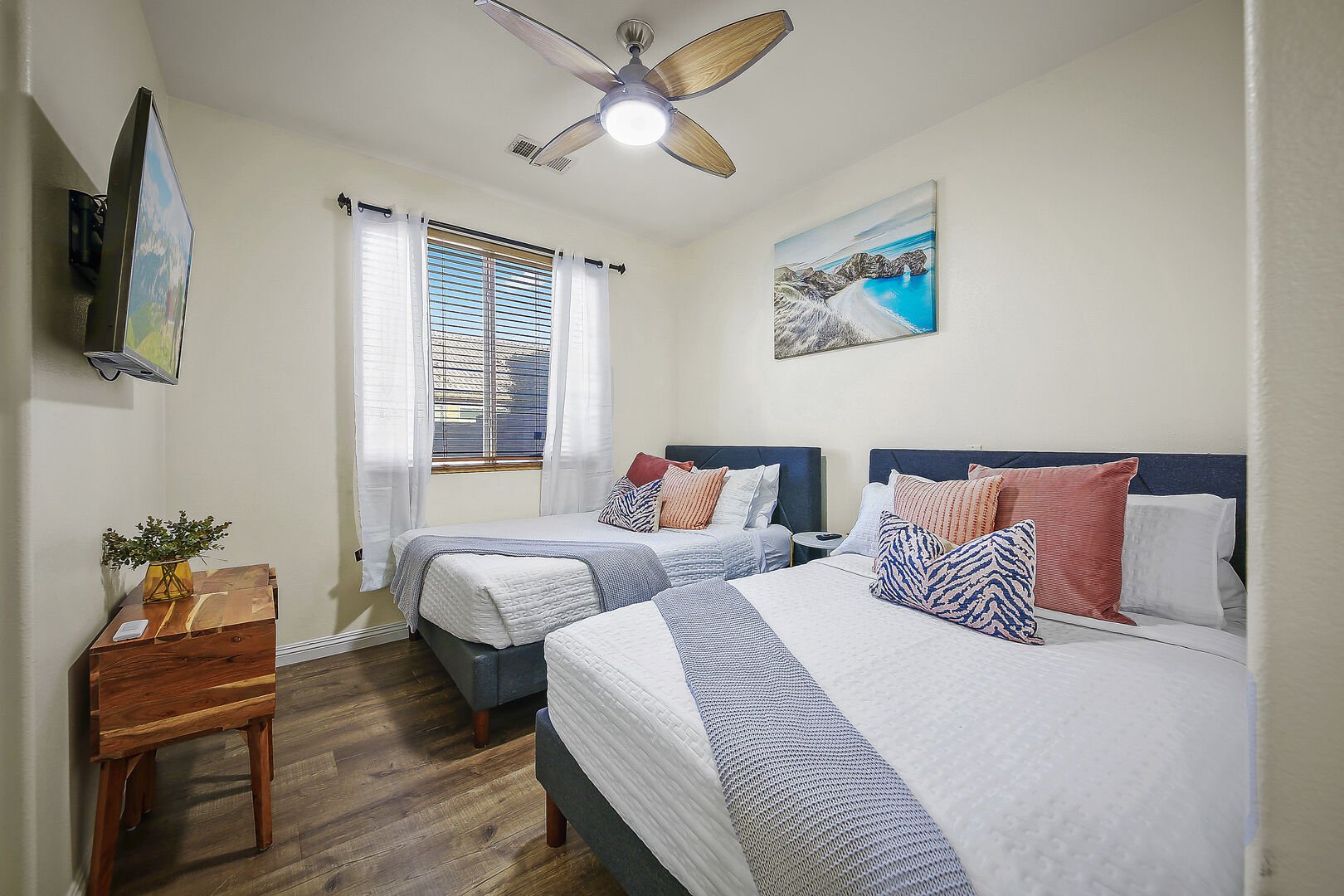 Bedroom 3 features two Full-sized Beds, 44-inch LG Smart television, a remote-controlled ceiling fan, and a reach-in closet.