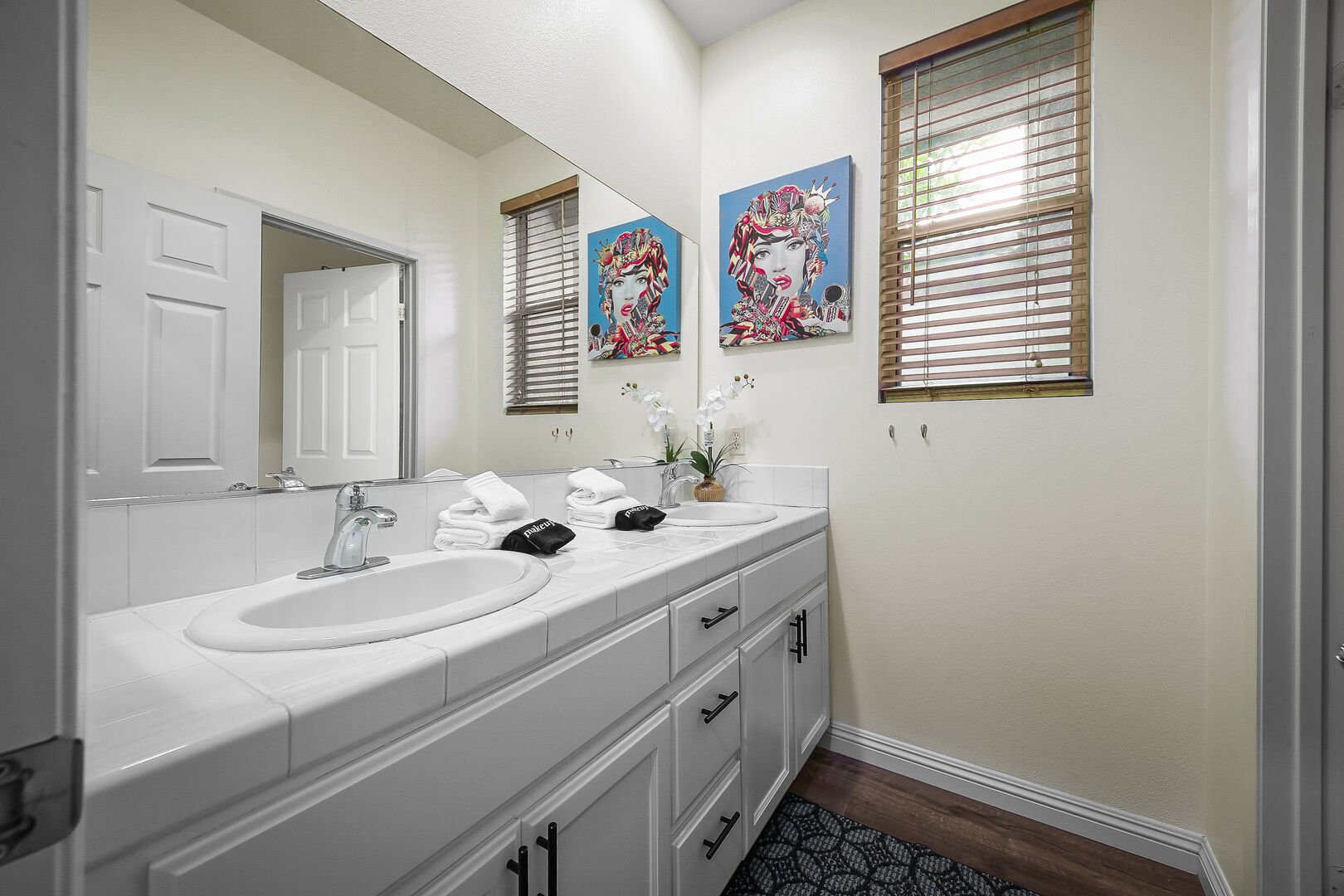 Hallway bathroom features a soaking tub, tile shower and a vanity sink.