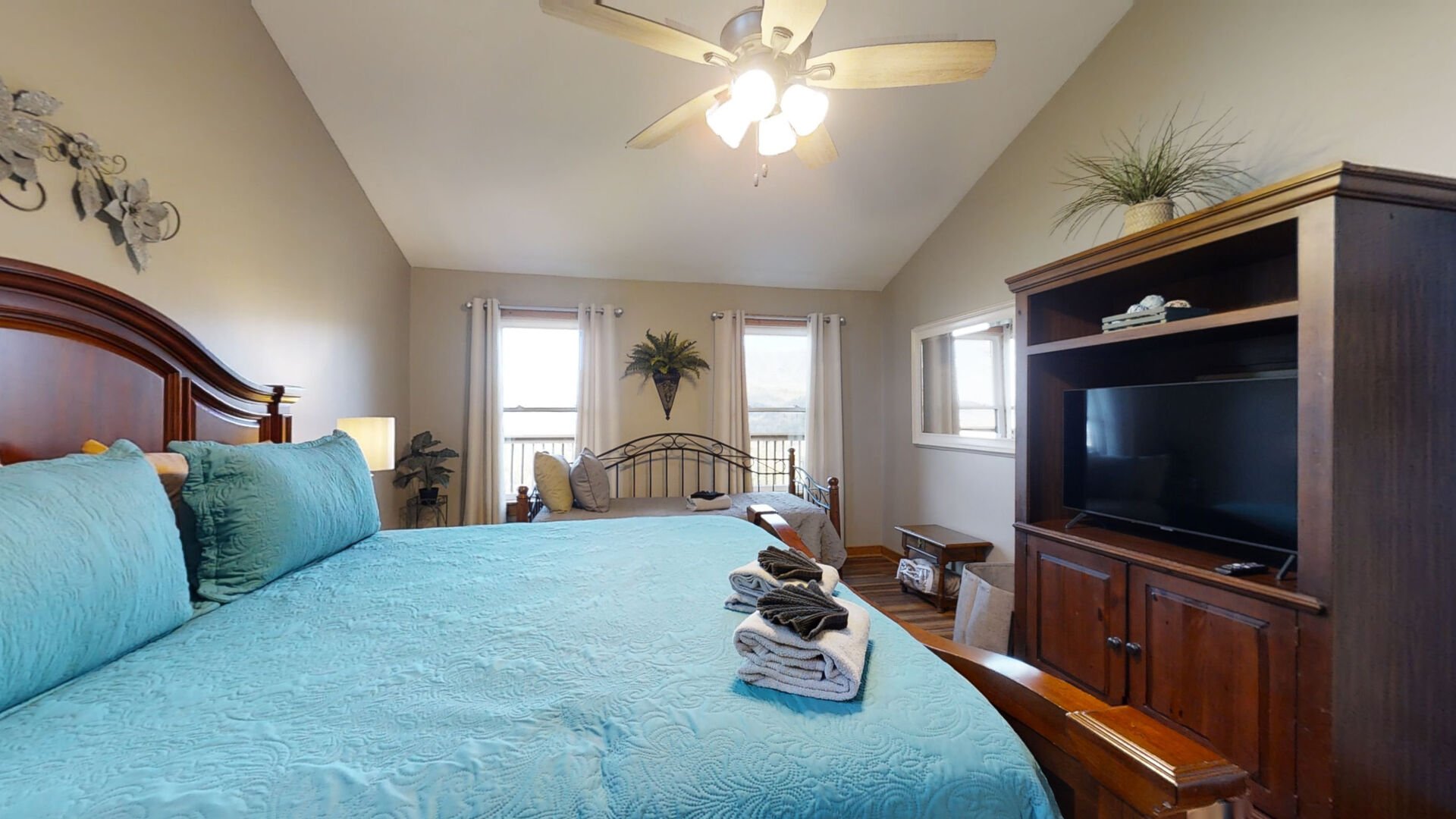 You'll have ample room to hang your clothes in the closet of this Master Bedroom #1. It has a big comfortable king sized bed, a comfortable twin bed, flat screen TV with remote, a ceiling fan and an air cleaner
