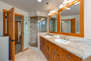 Master Bathroom with double sinks, tile & glass shower, and jetted tub