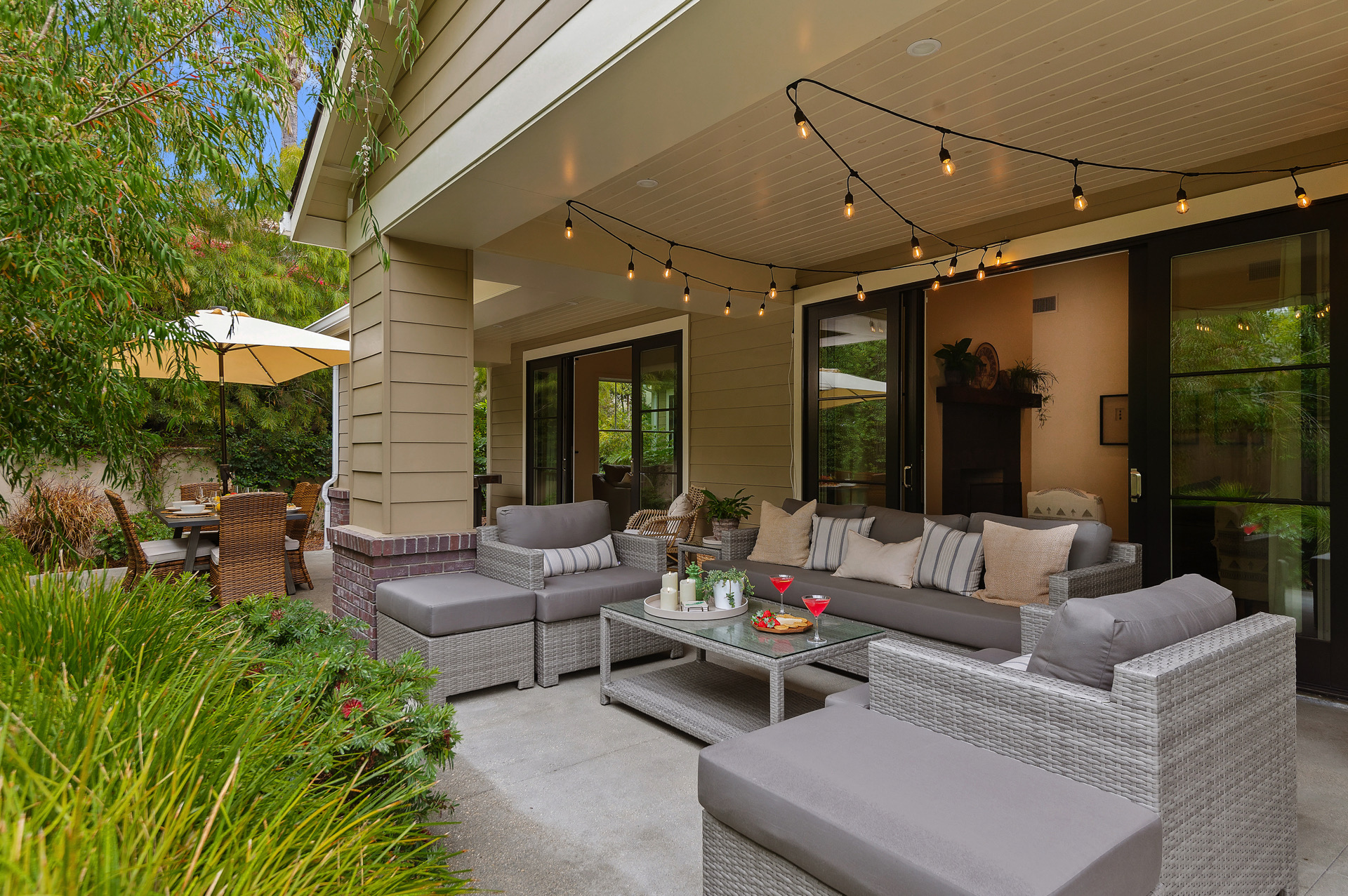 Outdoor space with lovely, comfortable couches and string lights.