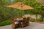 Dining area with umbrella and barbecue.