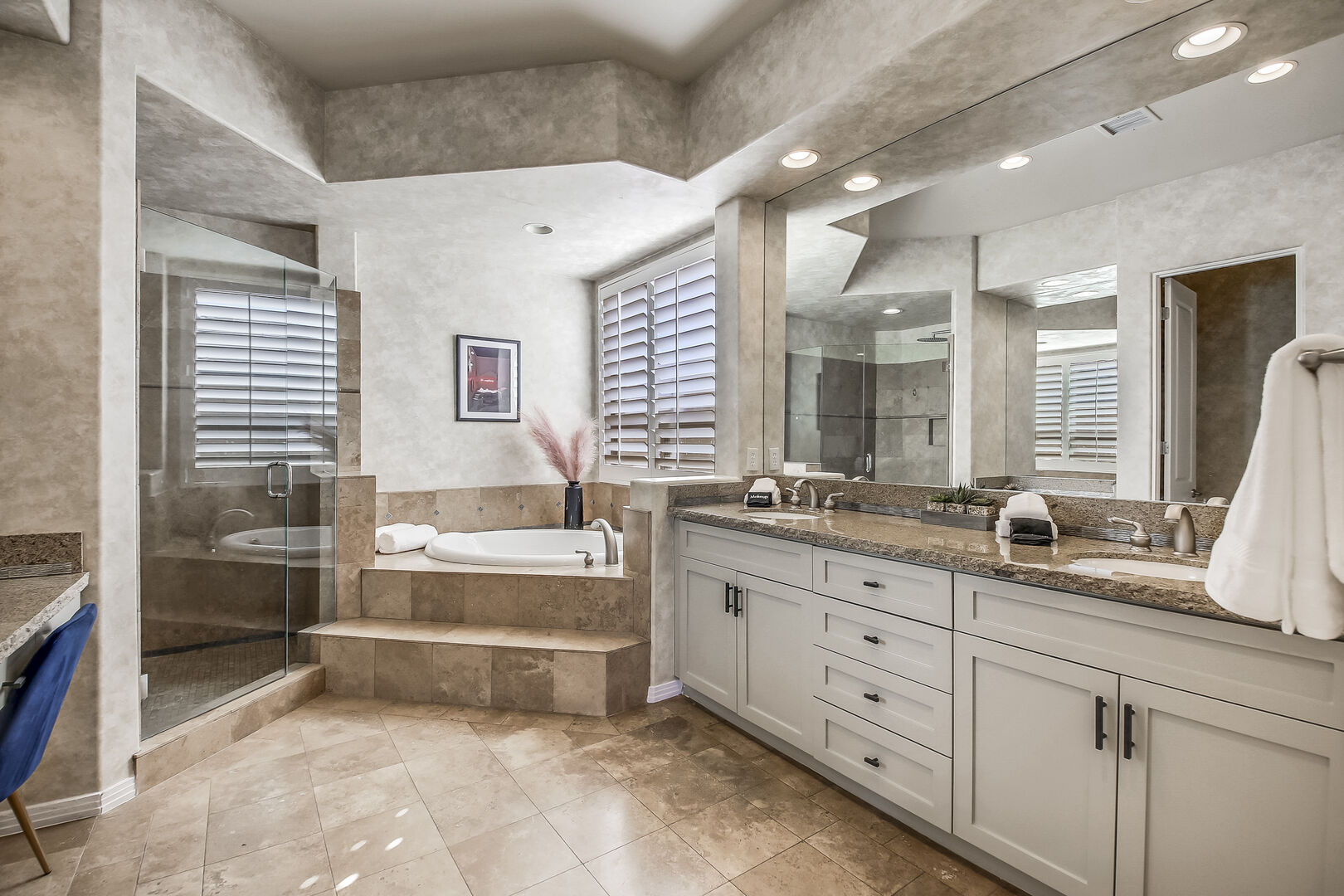 The private, en suite bathroom features a soaking tub and tile shower.