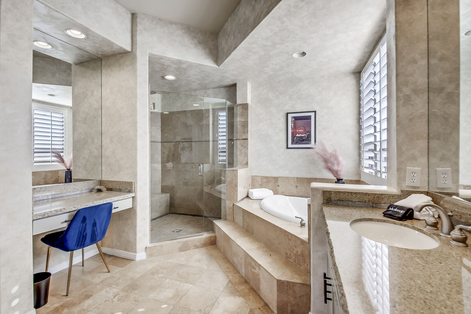 Master Suite 1 features double vanity sinks and a makeup counter.
