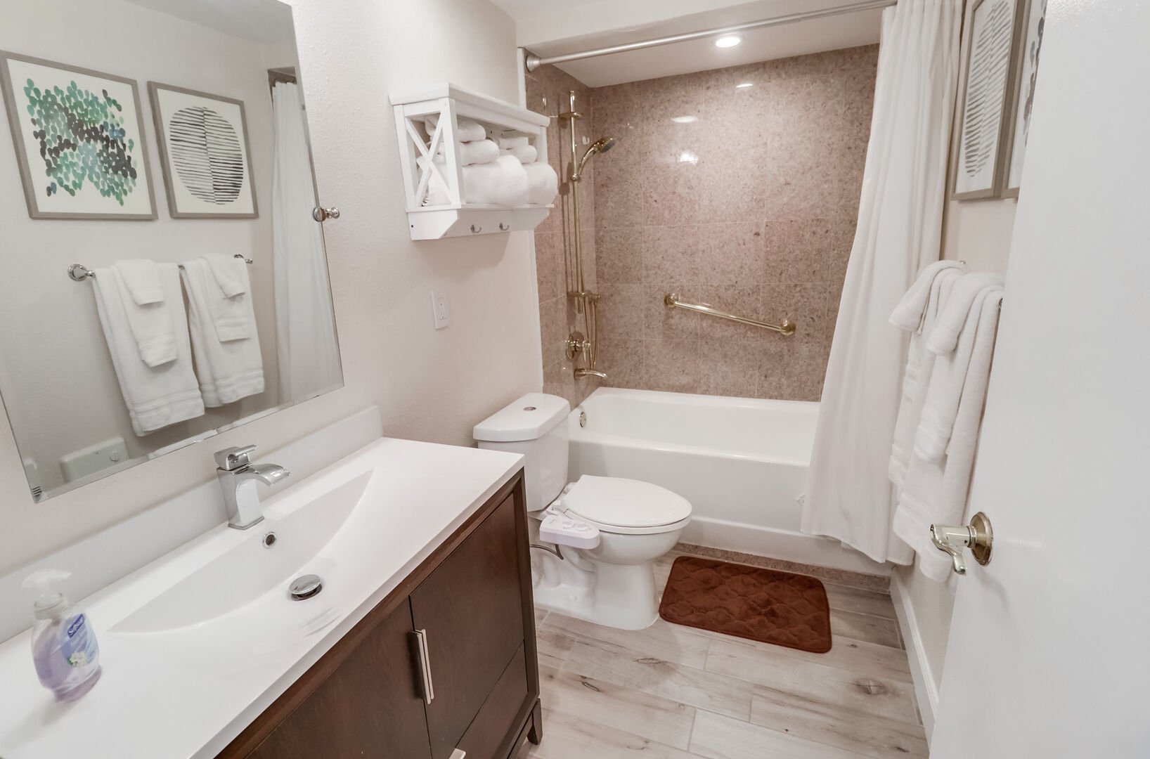 Full bathroom with shower/tub combo, vanity, ample storage space, toilet and bidet