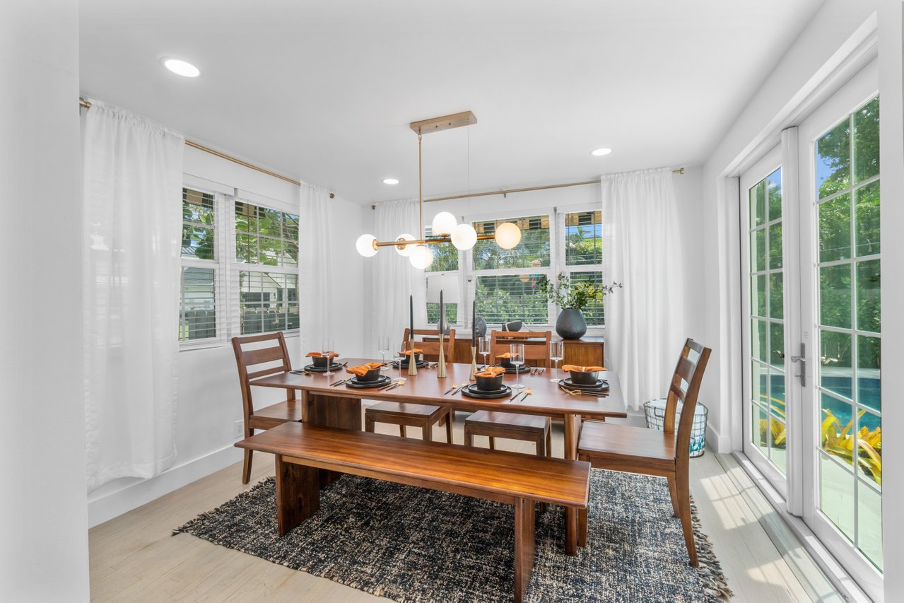 From the dining room, open French doors to an outside dining table for six by the heated pool.