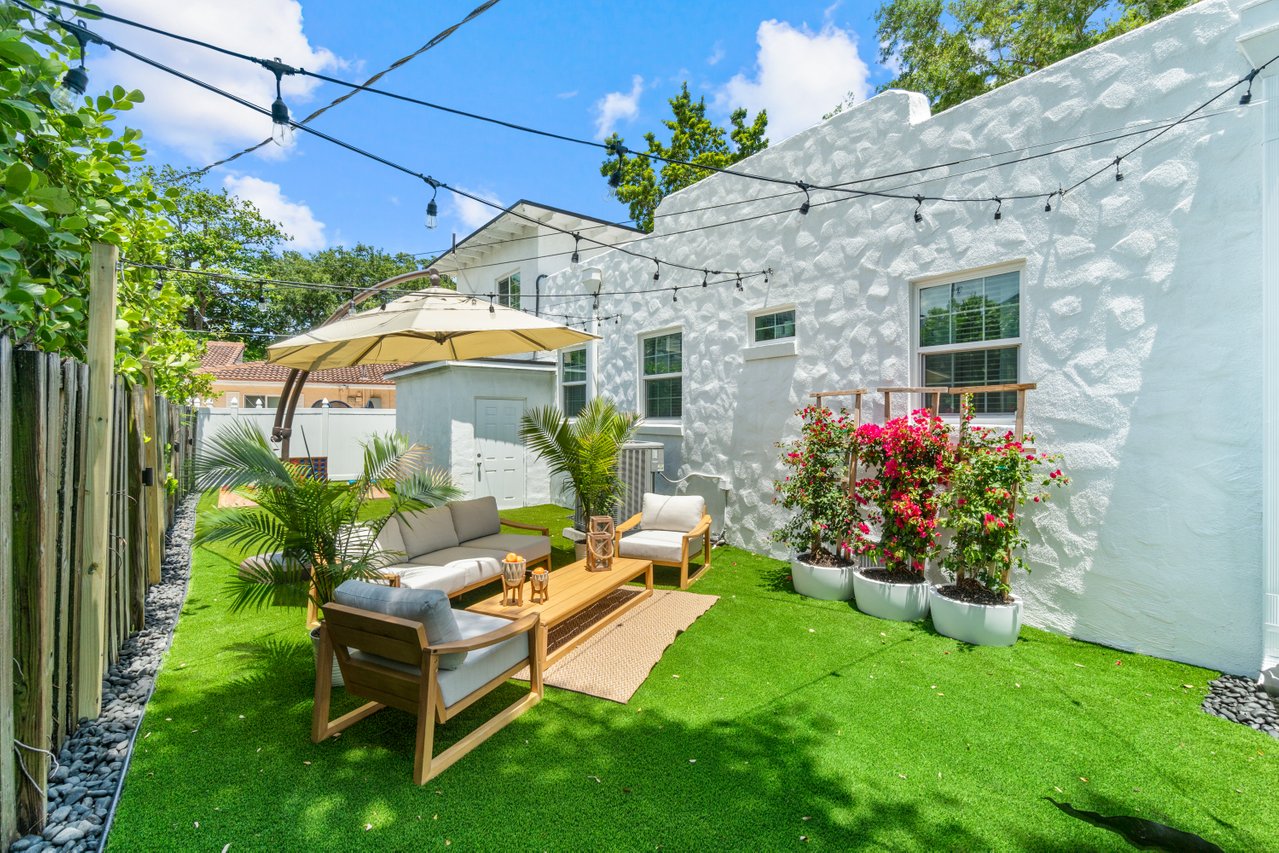 Backyard lounge area with popular lawn games. Urban lifestyle at its finest.