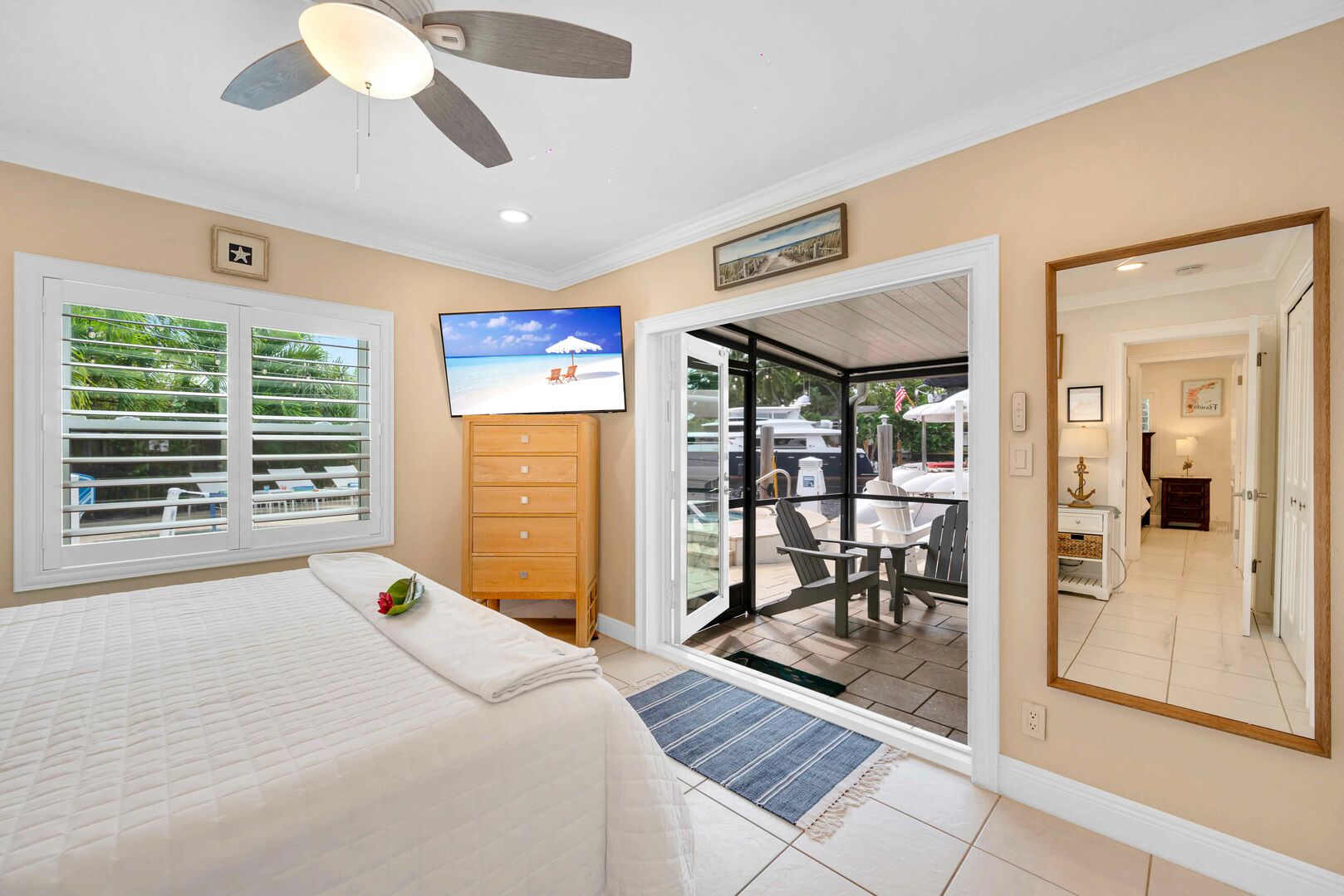 Bedroom 3 boasts a king bed and has direct access to the screened-in outdoor seating area. Perfect for sipping your morning coffee or enjoying the view of the pool and waterfront.