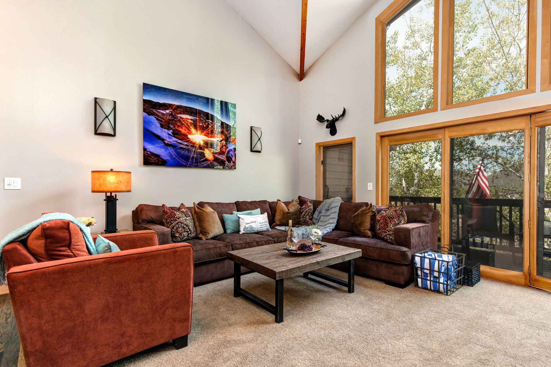 Living Room with plush furnishings, wood-burning fireplace, smart TV, and private deck access