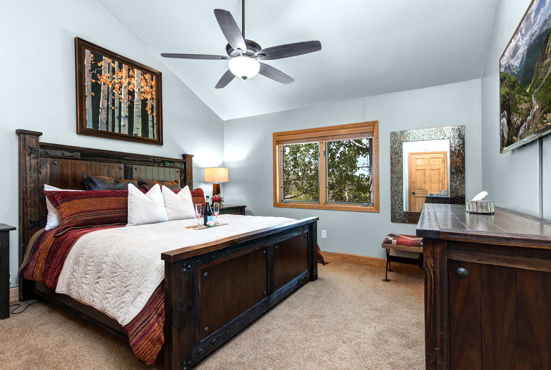 Main Level Master Bedroom with king bed, smart TV, and en suite bathroom