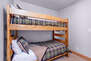 Entry Level Bedroom 3 with queen bed, twin over twin bunk bed, twin daybed, TV, patio access, and en suite bathroom