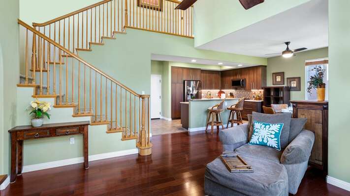 Open concept living, stairs leading to primary bedroom
