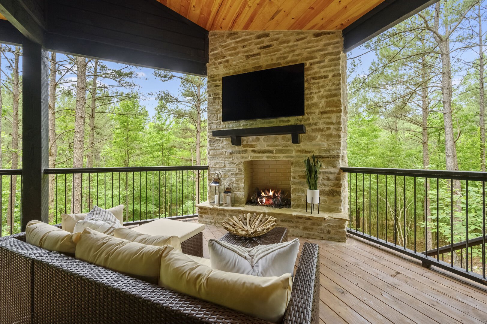 Outdoor patio includes a sitting area, flat screen TV, fireplace