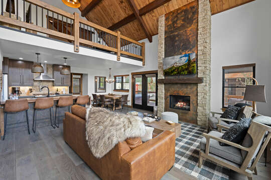 Cozy living area that looks into the kitchen with 25 foot tall fireplace and 50 inch smart TV