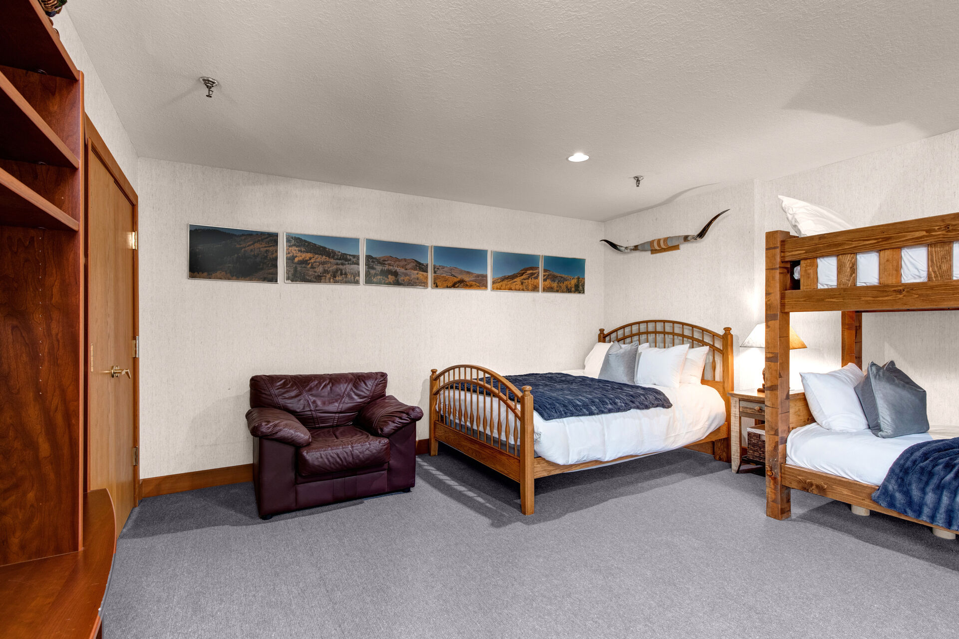 Lower Level Bunk & Game Room with plush leather sofa, twin over twin and twin over full bunk beds, full bed, smart tv, arcade games, ping pong table, private sauna, and full bath access