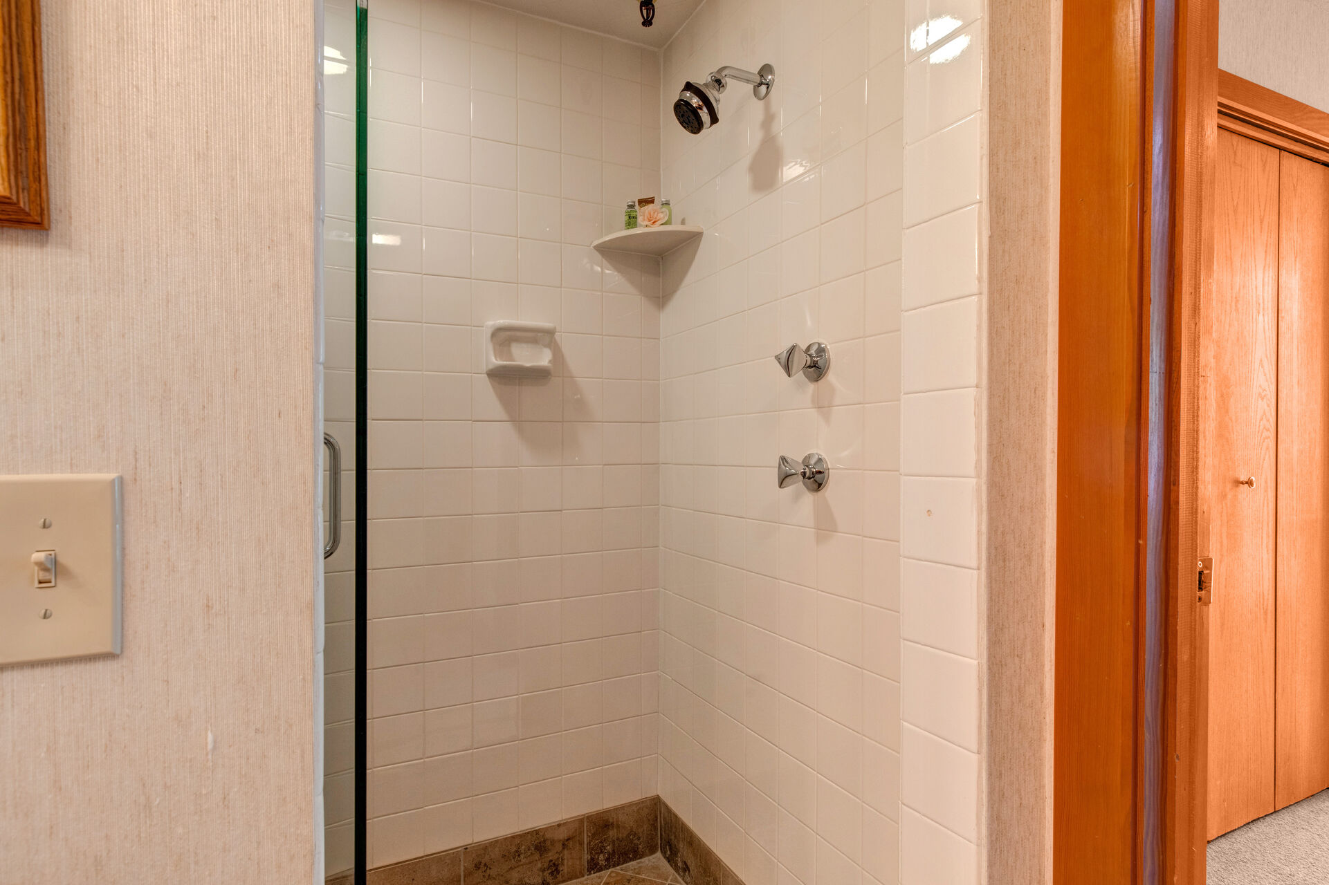 Lower Level Shared Full Bathroom with tile & glass shower and private sauna