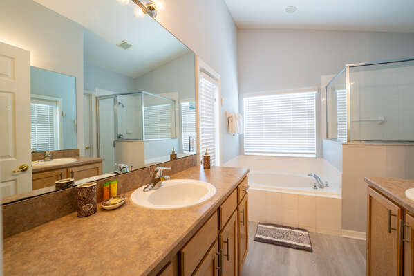Master bath showing tub and dual vanities