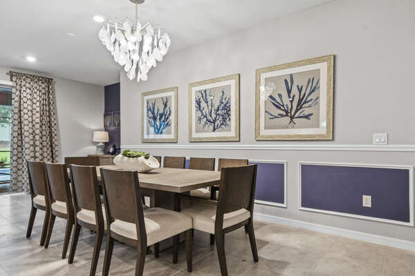 Bright and modern dining room with a wispy leaf chandelier