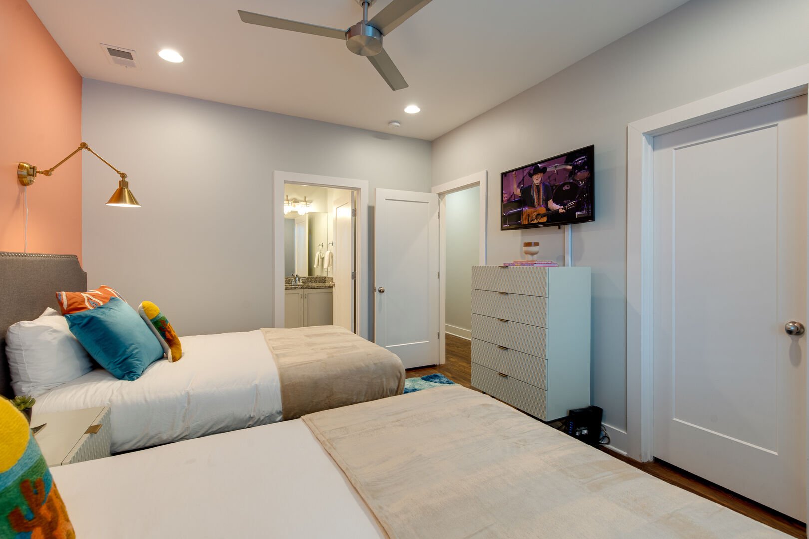 2nd bedroom with 2 Full size beds, walk in closet, smart TV, and en-suite bathroom.