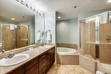 Master bathroom with double vanity, stand up shower and jetted bath tub