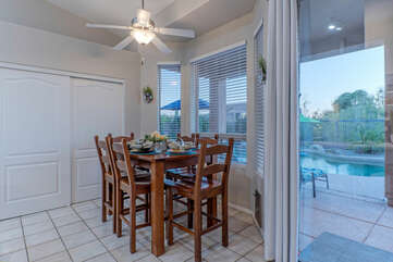 Breakfast nook in kitchen has a pleasing view of the patio and pool deck.