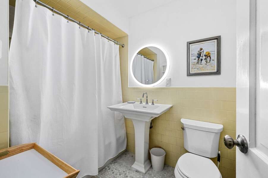 Full bathroom with modern light up mirror and tub/shower combination located in the hallway - 94 Joshua Jethro Road Chatham Cape Cod - Cape Escape - NEVR