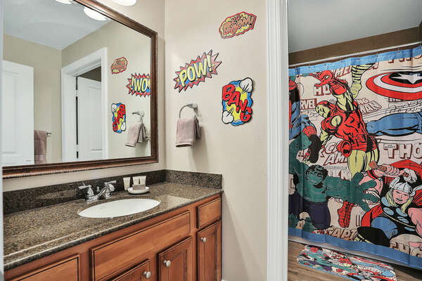 The two themed bedrooms have access to a fun superhero-inspired bathroom with combined tub/shower
