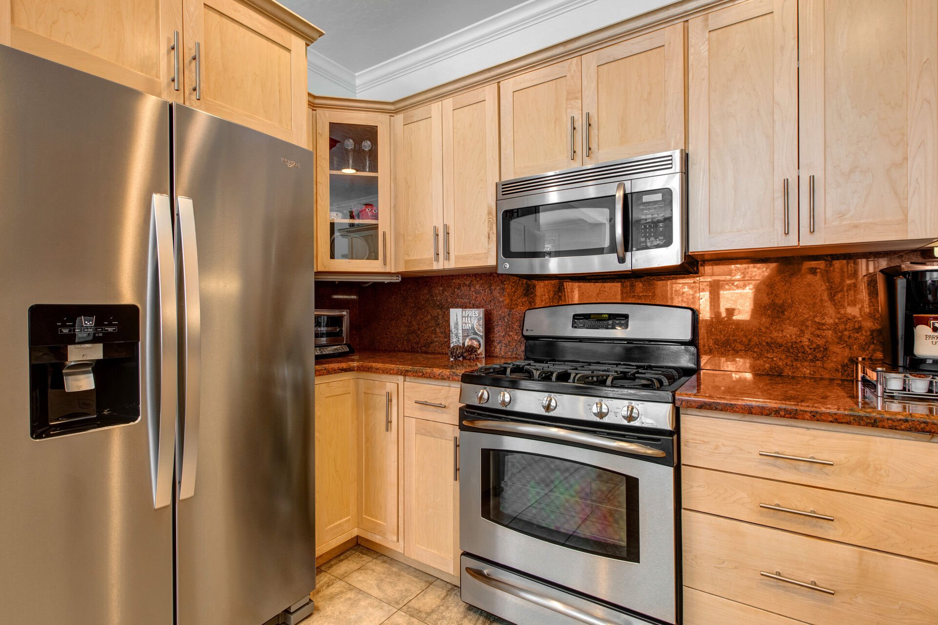 Fully Equipped Kitchen with gorgeous stone countertops, stainless steel appliances, ice maker, and bar seating for four
