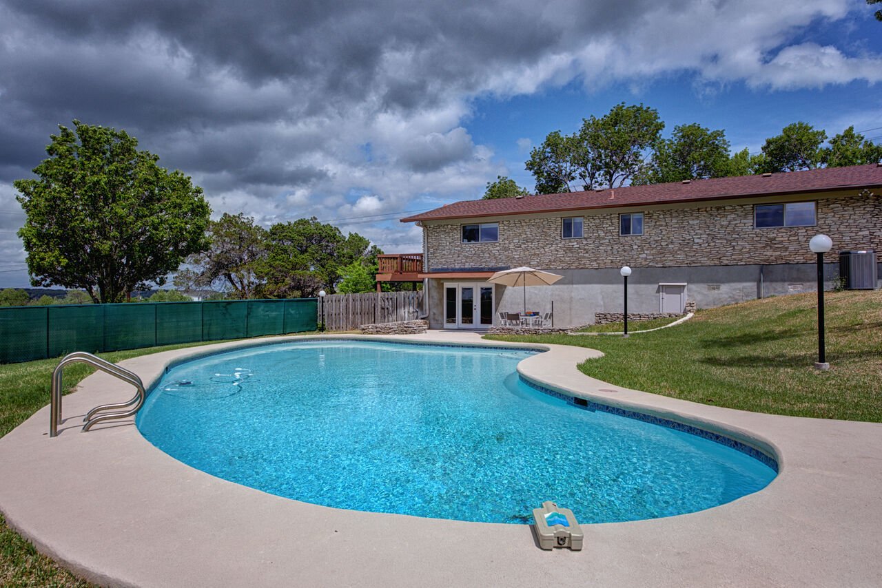 Huge fenced-in yard with an inviting pool for the warmer summer days