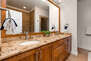Master Bathroom with double sinks, soaking tub, and separate tiled shower